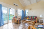Living Room with access to balcony overlooking resort grounds and Caribbean Sea thumbnail from Coldwell Banker